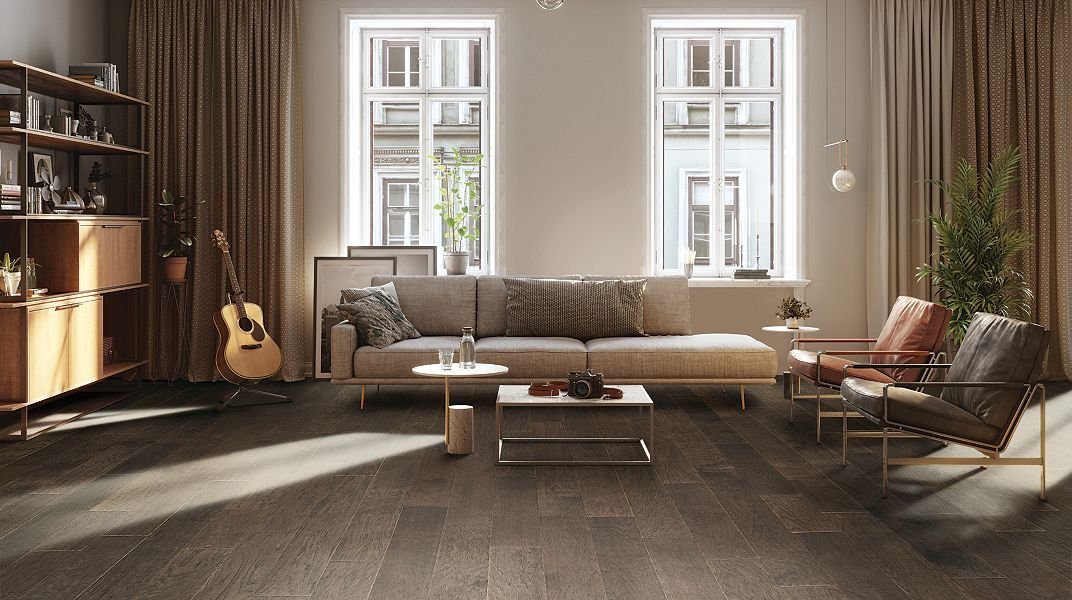 Hardwood floors in a living room with large windows.